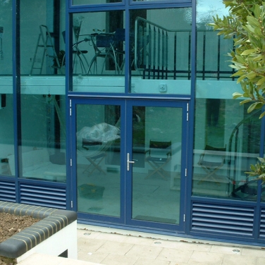 AVS50 Aluminium Glazed-In Louvres installed into residential curtain wall