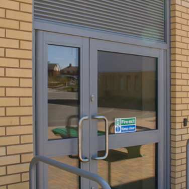 AVS34 Glazed-In Louvre fitted over Jack Aluminium Commercial Door